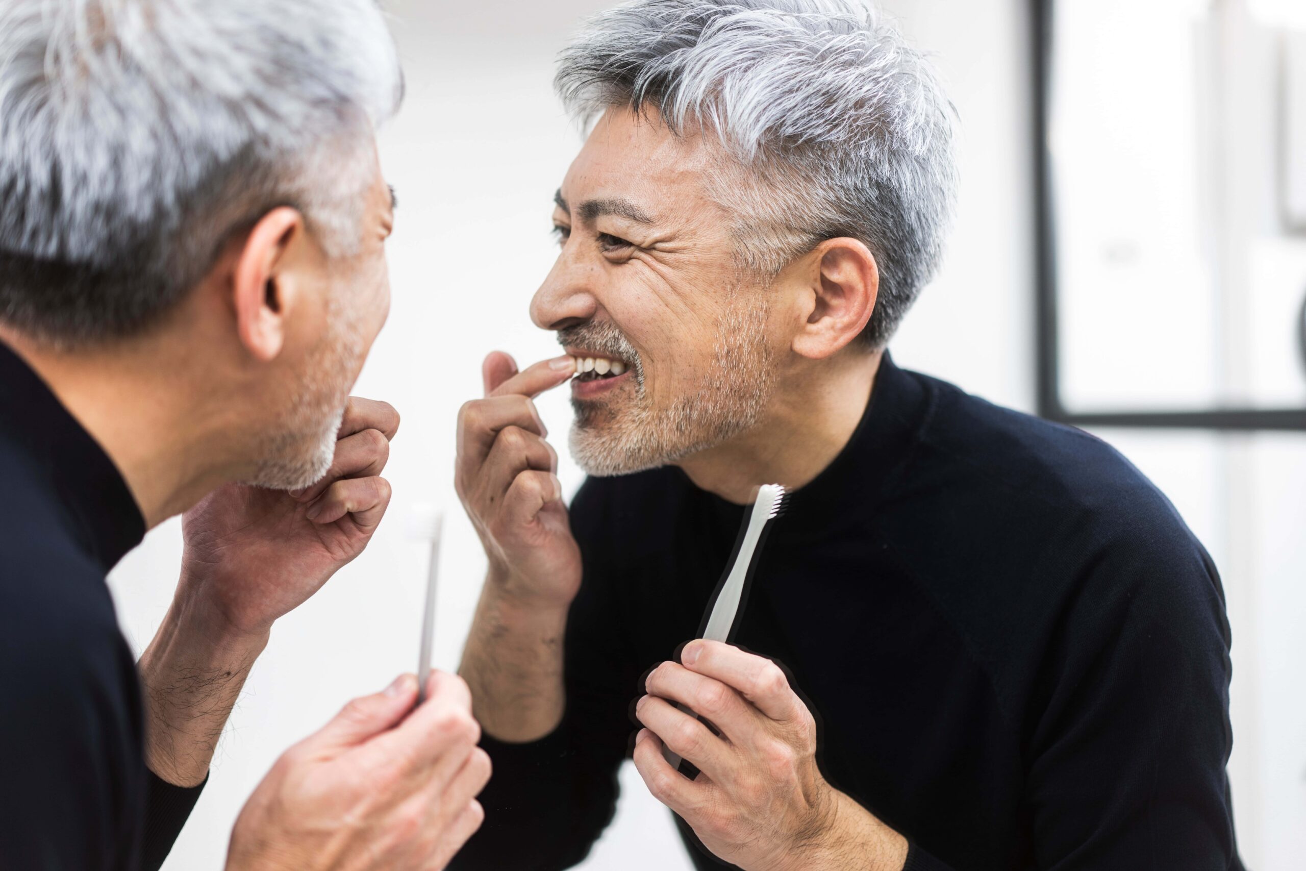 Middle Aged Man Checking His Teeth